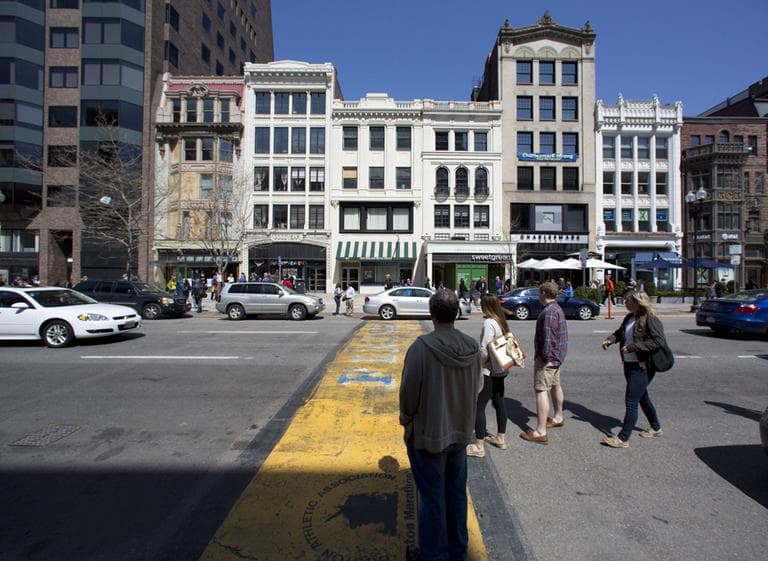 People pause on Boylston Street at the finish line of the Boston Marathon on Saturday afternoon.  (Robert F. Bukaty/AP)