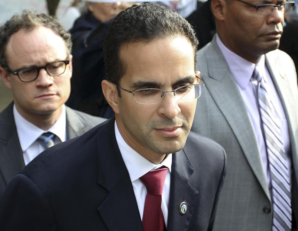 In this Oct. 24, 2011 file photo, Providence Mayor Angel Taveras, center, listens to Occupy Providence protesters as in a city park in downtown Providence. (Stew Milne/AP)