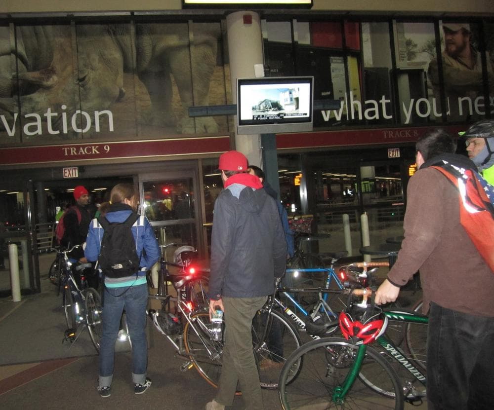 Cyclists line up to board the Mass. Bay Commuter Rail's special train to Southborough for the Midnight Marathon Bike Ride. (Emma-Jean Weinstein/WBUR)