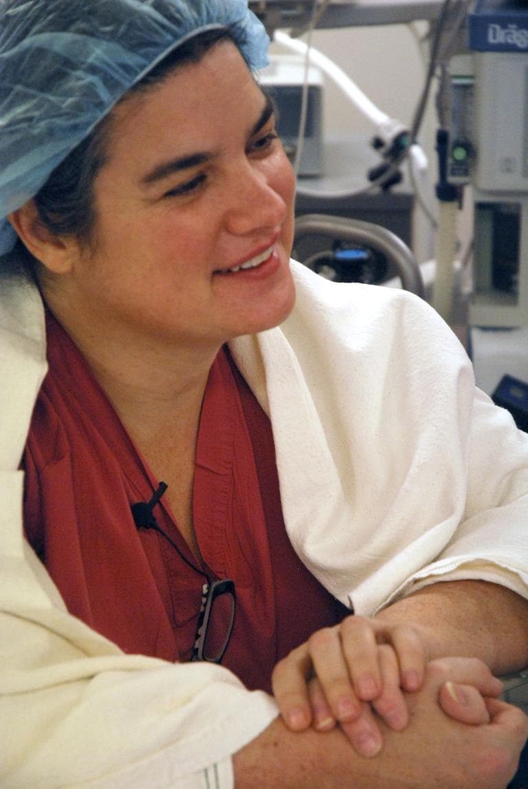 Dr. Susannah Rowe holds the hand of her patient Kevin Fitzgerald after surgery. (Photo: George Hicks)