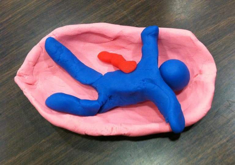 The ITC trainers asked everyone in the group to make a symbol that depicts the most meaningful event in the last month’s crisis. The ideas ranged from an American flag, to a dismembered body, to this boat. (Asma Khalid/WBUR)