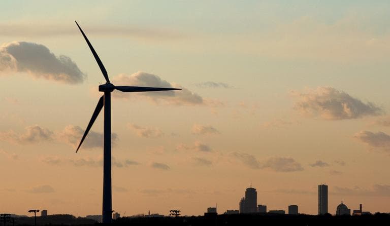 In this Feb. 24, 2006, file photo, a wind turbine stands, generating power next to Hull High School in the shadow of Boston. (Stephan Savoia/AP File)