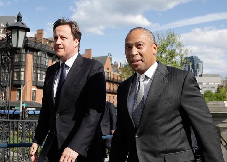 British Prime Minister David Cameron, left, walks with Gov. Deval Patrick into the State House in Boston Monday. (Elise Amendola/AP)