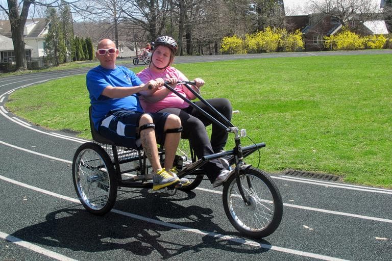Kaylene, 13, rides a tandem bicycle with her instructor, Shawn Bruhl. (Andrea Shea/WBUR)