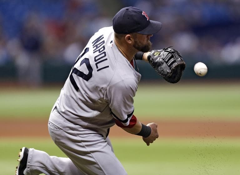 Red Sox first baseman Mike Napoli can't come up with a ball hit for a fourth-inning, two-run single by Tampa Bay Rays' Matt Joyce Tuesday night. Rays' Jose Molina, and Yunel Escobar scored on the hit. (Chris O'Meara/AP)