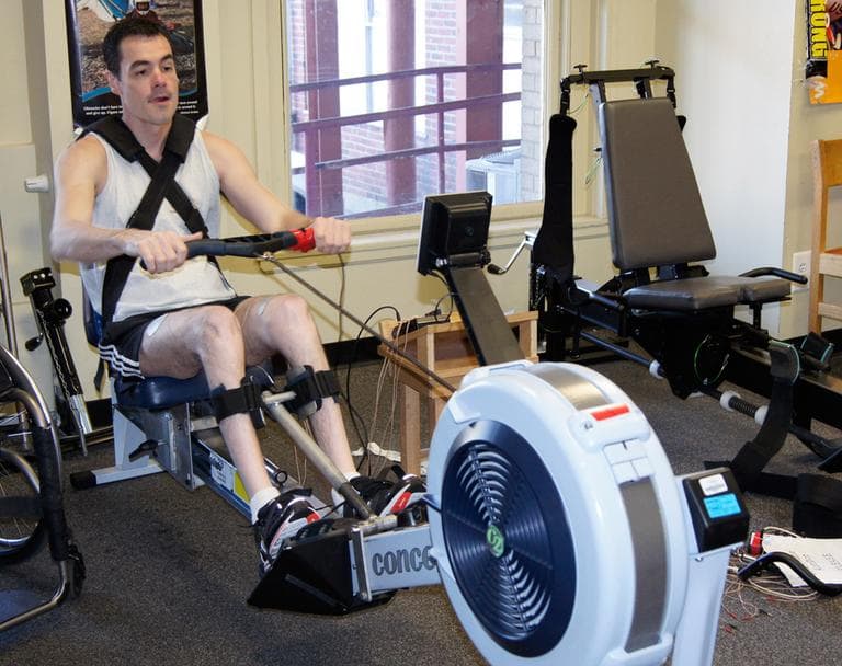 "You can’t rest your laurels on just sitting around and waiting for a cure," said David Estrada, seen here rowing at Spaulding Rehabilitation Hospital Cambridge. (Lynn Jolicoeur/WBUR)