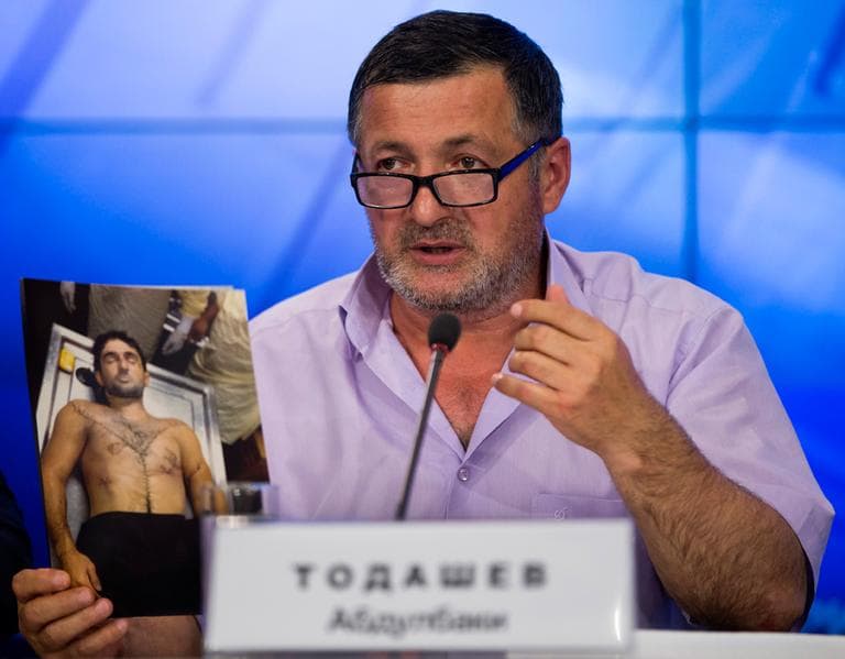 Abdul-Baki Todashev holds a photo he claims is of his dead son Ibragim Todashev, during a news conference in Moscow, Russia, Thursday. (Alexander Zemlianichenko/AP)