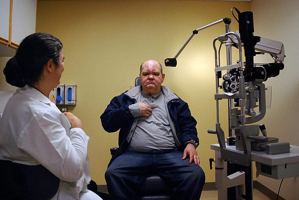 At a post-op check-up, Dr. Rowe checks to make sure Kevin is healing properly. (George Hicks/WBUR)