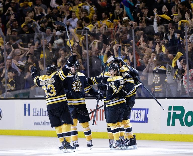 Boston Bruins left wing Brad Marchand (63), right wing Nathan Horton, second from left, and defenseman Torey Krug (47) celebrate a goal by defenseman Adam McQuaid (54) during the third period of Game 4 in the Eastern Conference finals of the NHL hockey Stanley Cup playoffs against the Pittsburgh Penguins, in Boston on Friday, June 7, 2013. (Elise Amendola/AP)