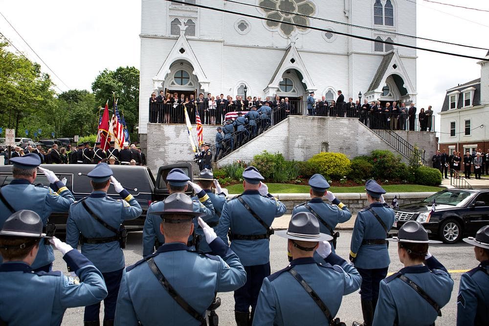 The late ex-Gov. Paul Cellucci's coffin is carried into St. Michael's in Hudson for his funeral Mass Friday. (Jesse Costa/WBUR)