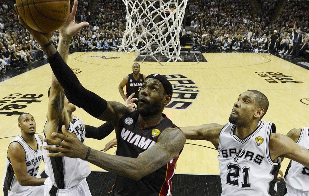 Miami Heat's LeBron James (6) shoots as San Antonio Spurs' Tim Duncan (21) defends during the first half at Game 5 of the NBA Finals basketball series, Sunday, June 16, 2013, in San Antonio. (Brendan Maloney/AP)