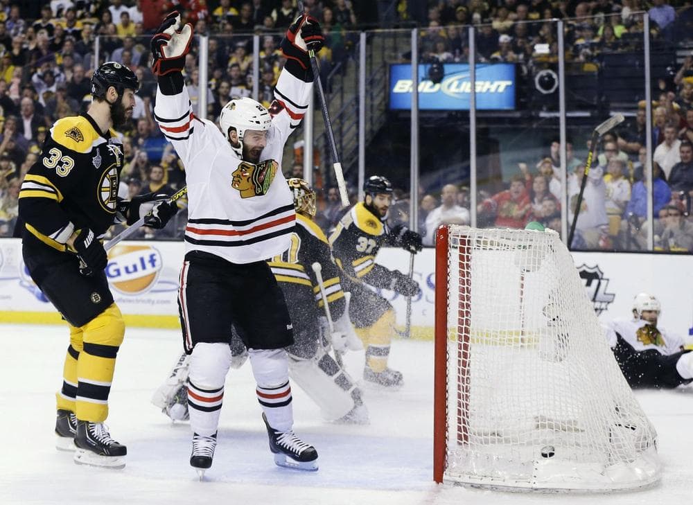 Chicago Blackhawks left wing Brandon Saad, center, celebrates a goal by Blackhawks center Michal Handzus, right, in front of Boston Bruins defenseman Zdeno Chara (33). (AP/Elise Amendola)