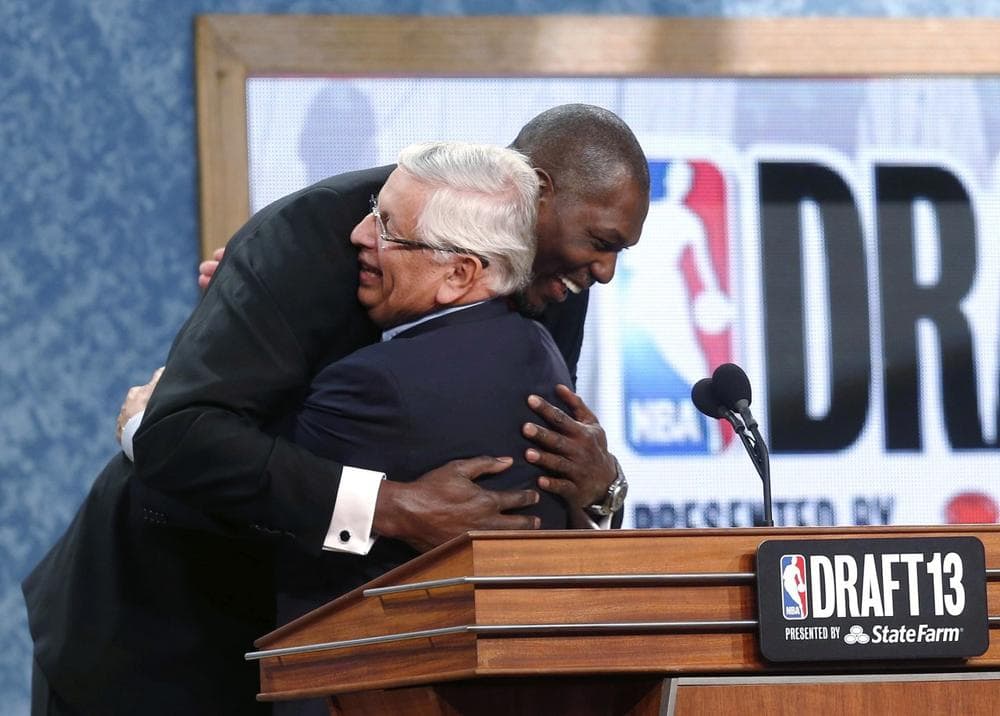 David Stern and Hakeem Olajuwon, No. 1 pick in 1984, hug on Thursday night. (Jason DeCrow/AP)