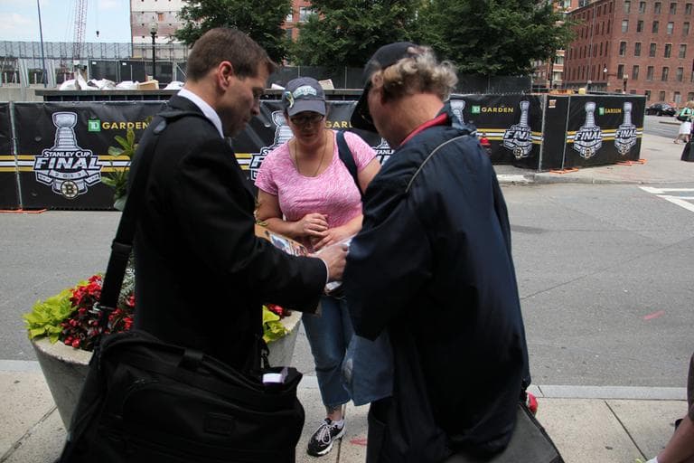 Retired NHL star and current assistant coach for the New York Islanders Dough Weight signs autographs. (Jared Bennett/ WBUR)