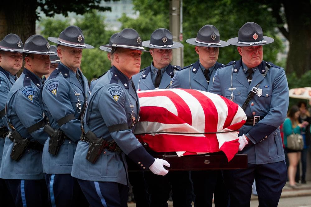 Honorary state police pallbearers carry Cellucci's casket into the State House. (Jesse Costa/WBUR)