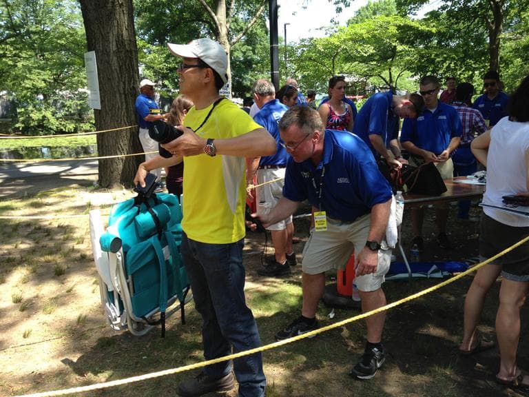 Spectators are "wanded" as they pass through a security checkpoint near the Hatch Shell. (Lynn Jolicoeur/WBUR)