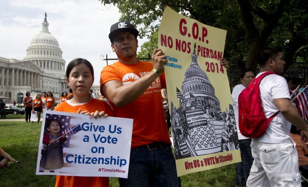 Brian Rossell, and his daughter Kelly Rossell, 11, both from Sonsonate, El Salvador, hold up placards as they join immigration supporters during a rally for citizenship on Capitol Hill in Washington, July 10, 2013. (Manuel Balce Ceneta/AP)