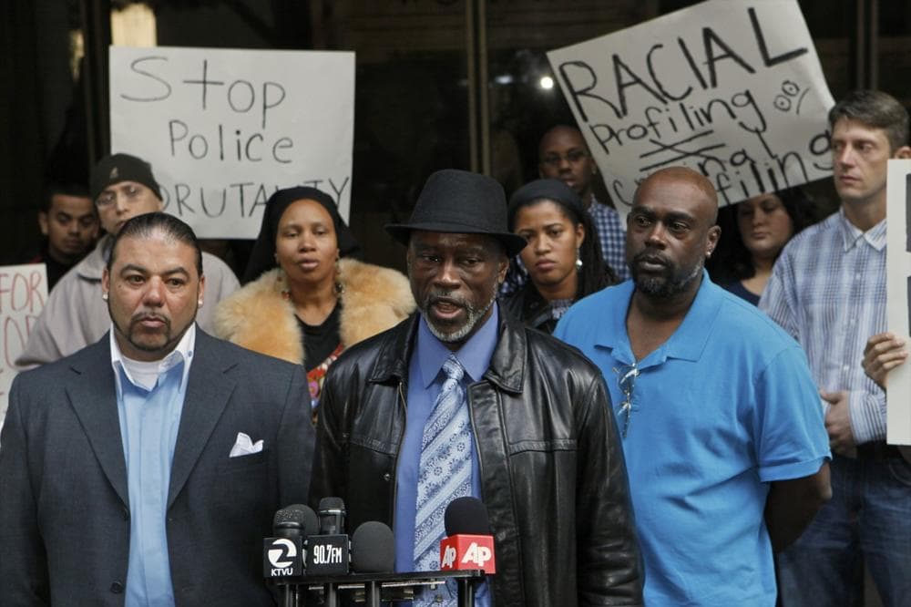 Oscar Grant's uncles: Cephus Johnson, middle, at podium, and Kenneth Johnson, right, comment on the denial of bail for ex transit officer Johannes Mehserle, outside the Los Angeles Superior Court on Friday, Dec. 3, 2010. At left is Jack Bryson. (Damian Dovarganes/AP)