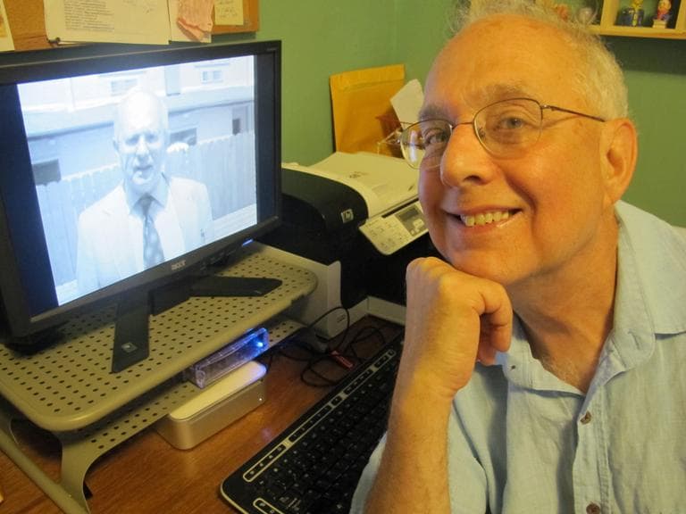 Film critic Gerald Peary watches himself act in "Computer Chess." (Andrea Shea/WBUR)