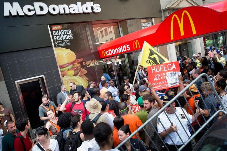 Demonstrators in support of fast food workers protest outside a McDonald's as they demand higher wages and the right to form a union without retaliation Monday, July 29, 2013, in New York's Union Square. (John Minchillo/AP)
