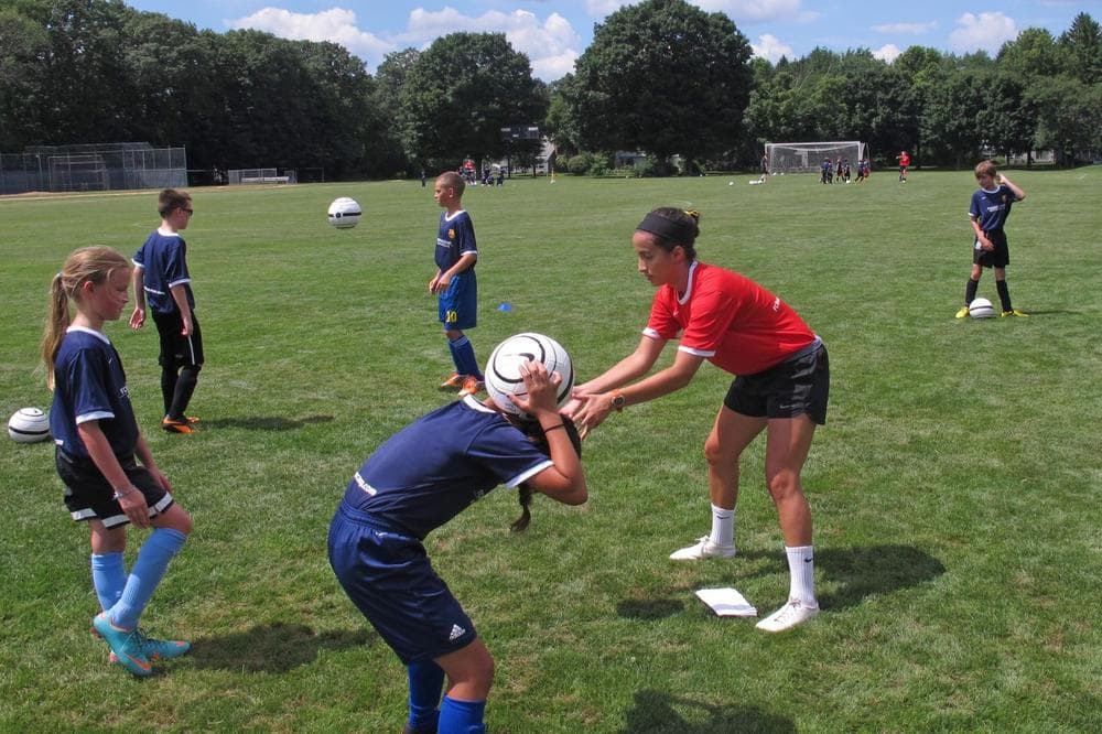 A coach runs a camper through drills at FC Barcelona's soccer camp in Concord, Mass. (Bill Littlefield/Only A Game)