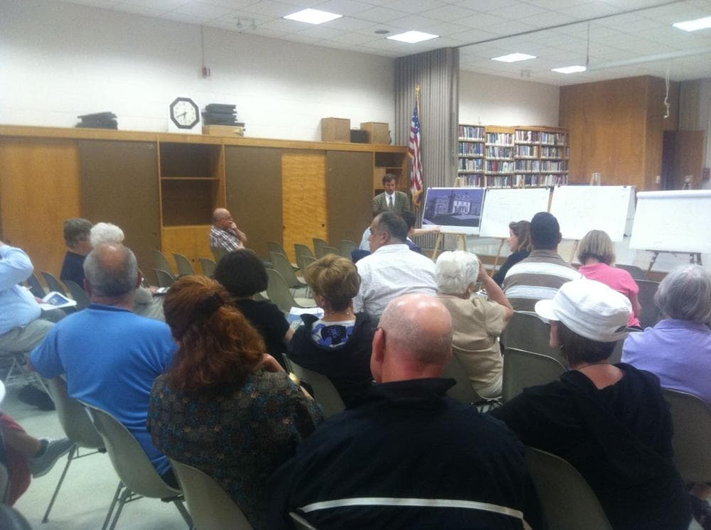 Skeptical longtime South Boston residents listened to an architect present a condo renovation plan for a historic building. (Curt Nickisch/WBUR)