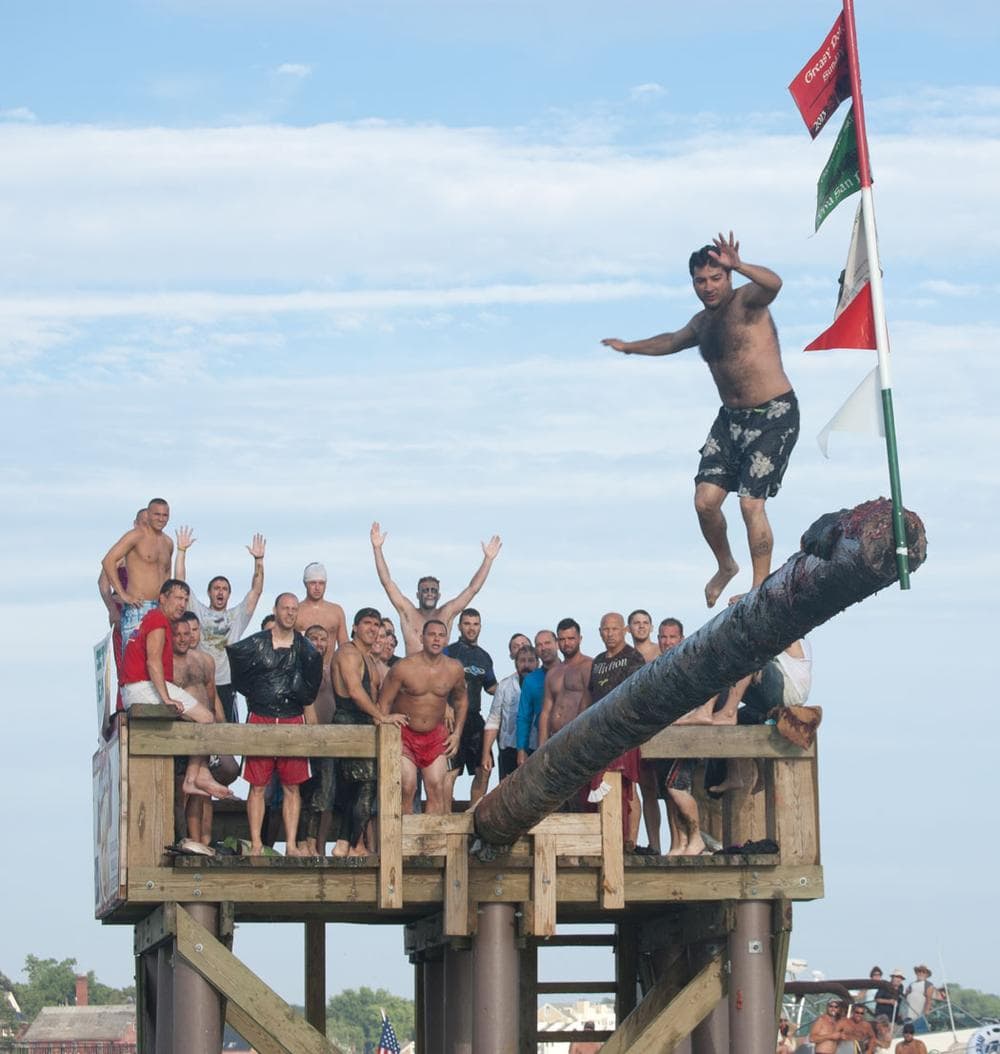 Nick Avelis, who won the Greasy Pole contest during the Saturday competition in 2012, steps carefully to the end to win again yesterday. (Greg Cook)