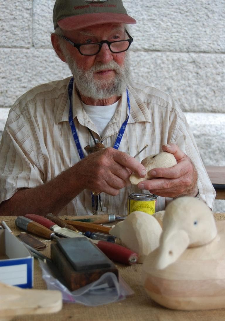 I can have [decoy] scoters out and long-tailed ducks and eiders will fly right by,” says hunter and wood carver Bob Brophy of Essex, who was adding glass eyes to the head of a female white-winged scoter duck decoy. “Birds of a feather.” (Greg Cook)