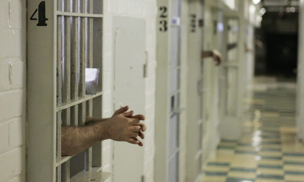 Prisoners reach through the bars at the Oklahoma State Penitentiary in McAlester, Okla., Jan. 18, 2008. Sometimes they use small mirrors to get a glimpse of their neighbors and the correctional officers. (AP)