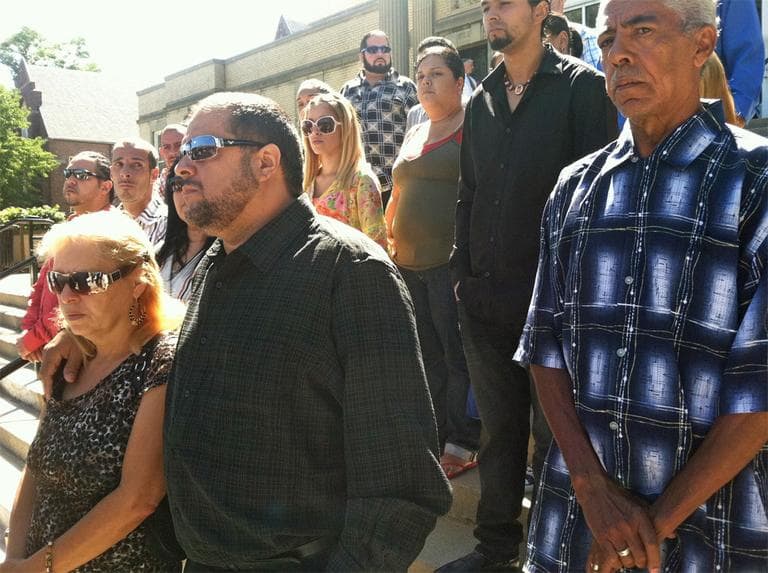 The parents (front left) and family of Edwin Alemany stand outside the West Roxbury District Court Thursday during a press conference held by his lawyers. (Delores Handy/WBUR)