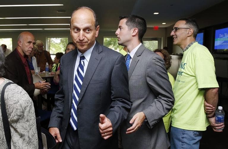 Dan Wolf, third from right, greets a supporter at the state Democratic Convention last month in Lowell. (Michael Dwyer/AP)