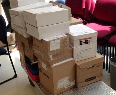 Some of the medical marijuana dispensary applications submitted to the state Thursday (Lynn Jolicoeur/WBUR)