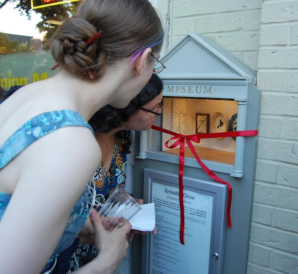 Visitors peek into the Mµseum. (Greg Cook)