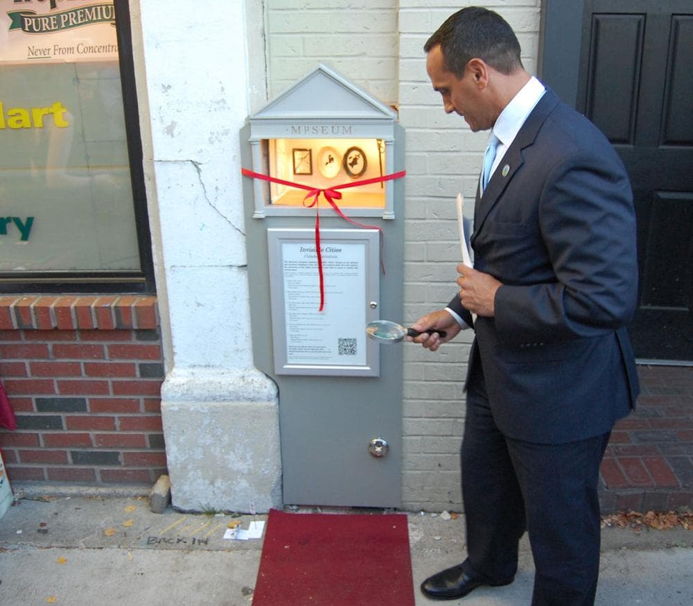 No idea is really too big or too small to hit it big in Somerville,” said Mayor Joseph Curtatone, who brought along a magnifying glass to help enjoy the Mµseum. (Greg Cook)