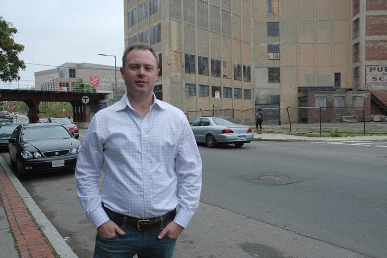 Bill Forry, editor/publisher of The Dorchester Reporter, stands in front of the vacant Leon Electric building in Dorchester's Uphams Corner. (Lynn Jolicoeur/WBUR)