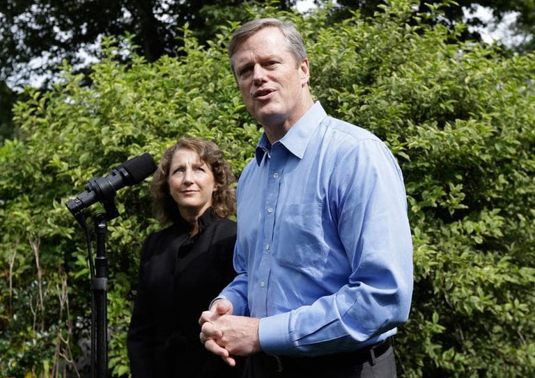 Gubernatorial candidate Charles Baker faces reporters at his Swampscott home Thursday, as his wife Lauren looks on. (Steven Senne/AP)