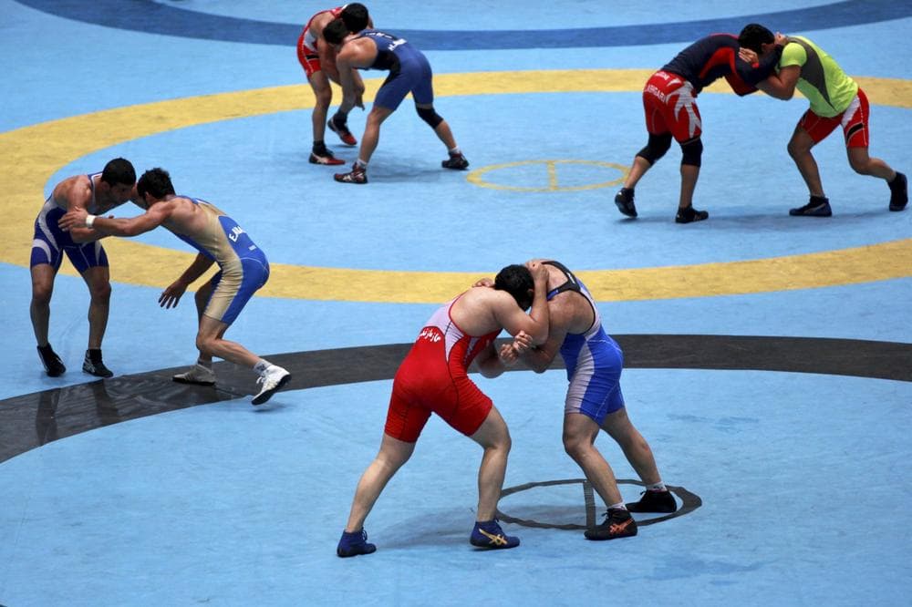 The IOC has reinstated wrestling to the 2020 Olympic Games, hosted by Tokyo, giving the Iranian free-style wrestling team golden dreams. (Ebrahim Noroozi/AP)