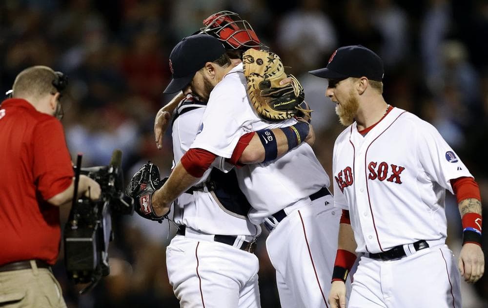 Red Sox's John Lackey, center right, hugs Jarrod Saltalamacchia, center left, after pitching a complete game and defeating the Baltimore Orioles.(AP/Michael Dwyer)