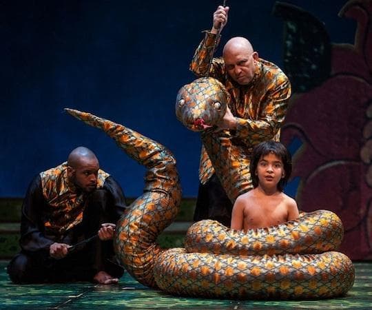 Timothy Wilson and Akash Chopra encircled by a snake manipulated by Thomas Derrah in "The Jungle Book." (Liz Lauren)