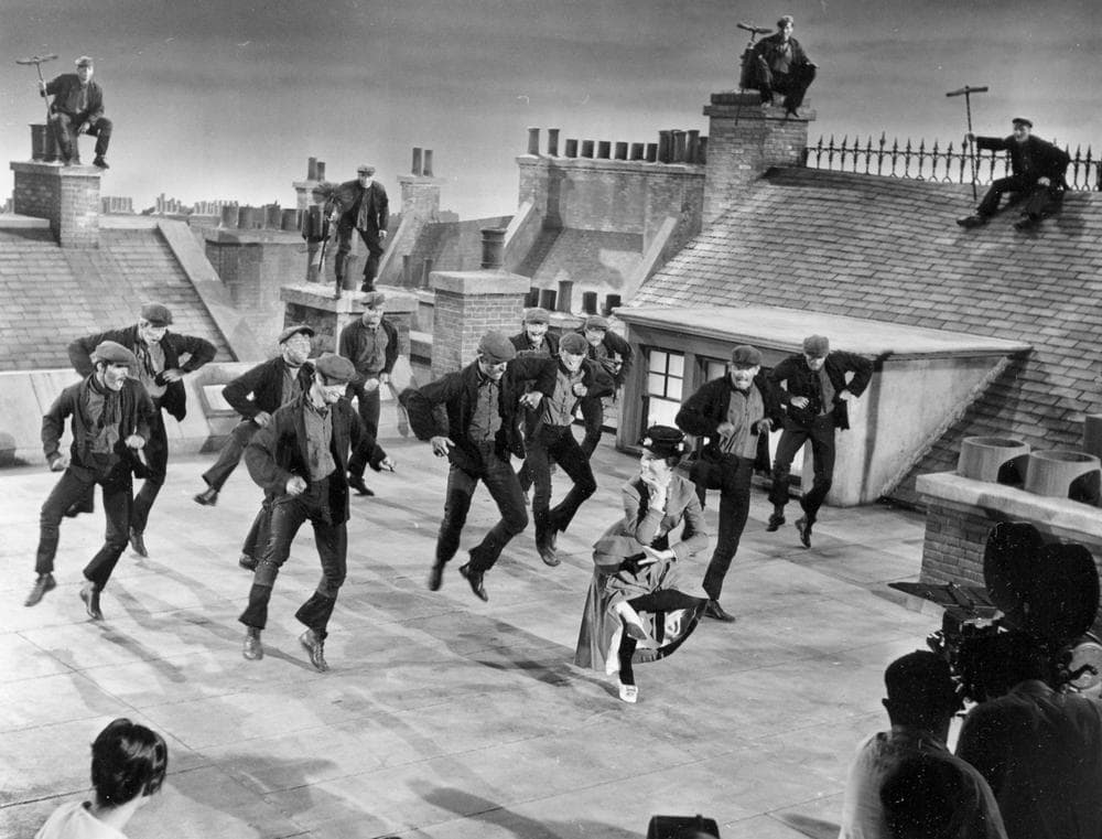 Actress Julie Andrews dances with the chimney sweeps in the chimney-sweep dance number during filming of "Mary Poppins" on a movie set representing London rooftops at the Disney Studios in Hollywood, Ca., Aug. 16, 1963. (AP)