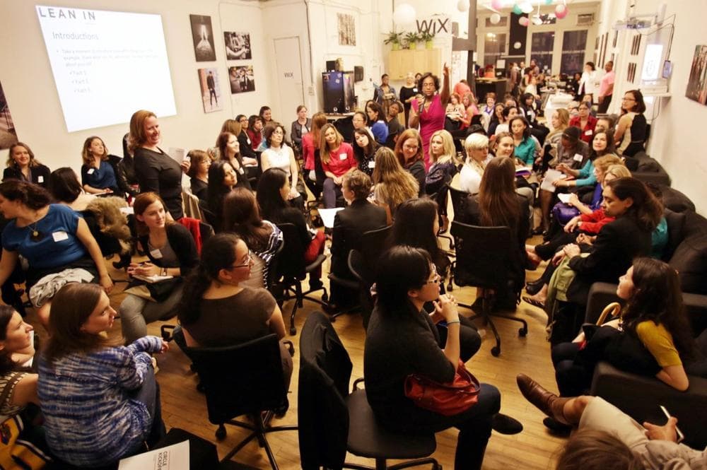 This April 16, 2013 photo provided by Wix Lounge shows group facilitator Franne McNeal, right, standing, and organizer Mary Dove, standing left, addressing women at a "Lean In" meeting in New York. The group is inspired by Facebook COO Sheryl Sandberg's book "Lean In" which seeks to empower women in the workplace. (AP Photo/Wix Lounge, Galo Delgado)