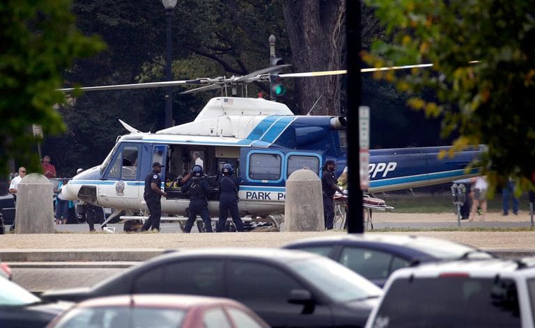 A U.S. Park Police helicopter is loaded on the Mall in Washington Thursday with a wounded person. (Alex Brandon/AP)