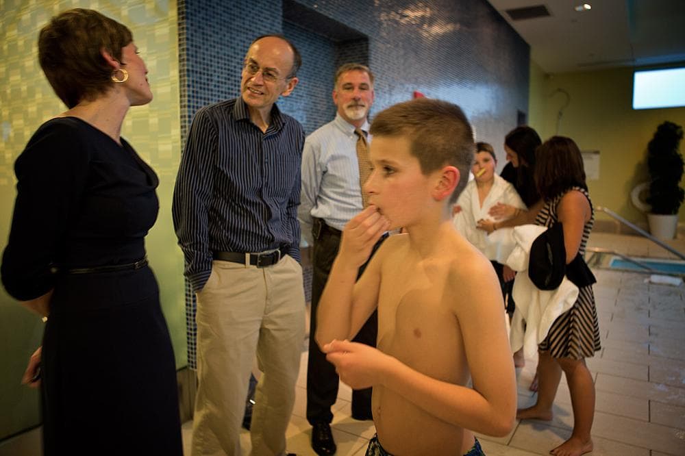 Stuart Supple, 10, foreground, and his brother, Timmy, love spending time in pools. That's why their mother, Kate, left, thought it would be the best place for them to meet Dr. Thomas Sudhof, the man whose been studying their genes for five years. (Jesse Costa/WBUR)