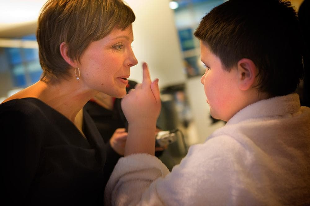 Timmy Supple, 8, enjoys pointing from his mother’s nose to his own. (Jesse Costa/WBUR)