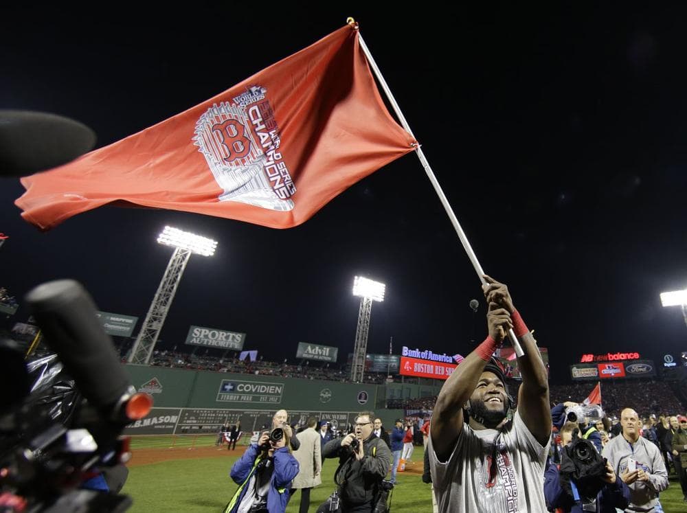 David Ortiz waves a flag after Boston defeated St. Louis to win the World Series Wednesday. (Matt Slocum/AP)