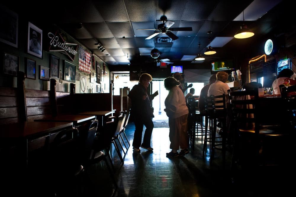 Joan Conley, a retired Massachusetts state trooper, and Frances Morrill, both of Revere, dance to the music playing on the jukebox in Eddie C’s. (Jesse Costa/WBUR)