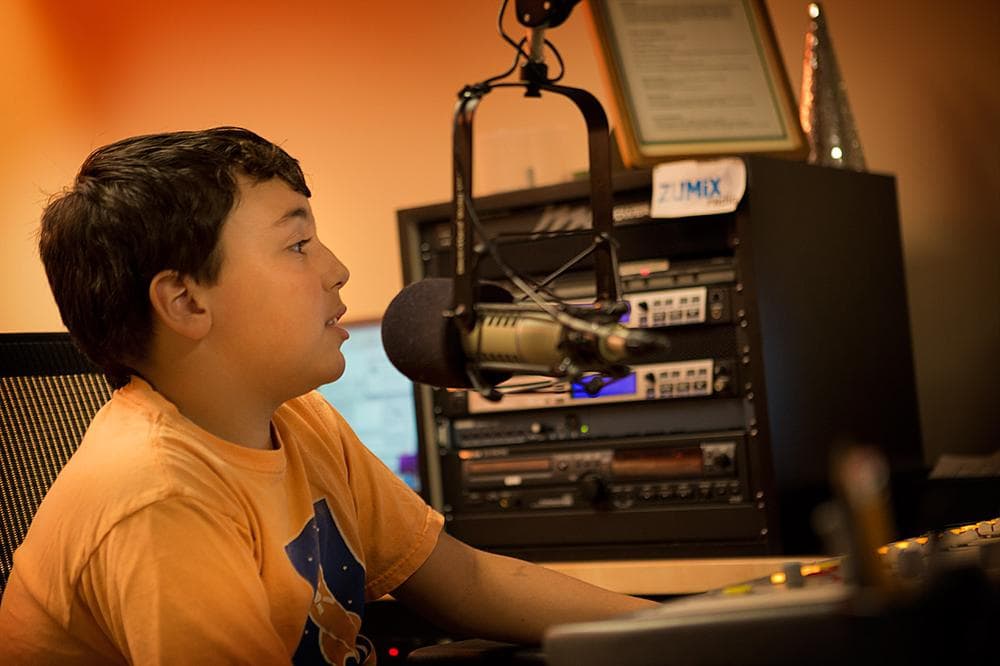 A student tapes his radio show at the Zumix Community Arts Center in Maverick Square. (Jesse Costa/WBUR)