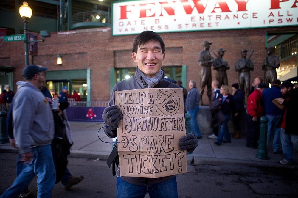 Northeastern student Eric Chin of Dorchester looks for a ticket to Game 6 of the World Series. (Jesse Costa/WBUR)