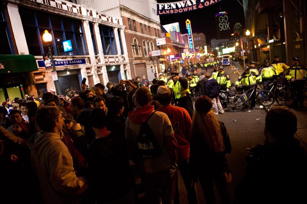 Police move people out of Lansdowne Street by using bicycles as barricades. (Jesse Costa/WBUR)