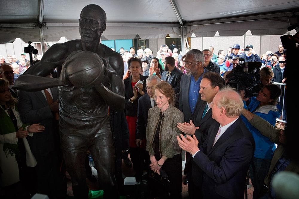 Bill Russell’s daughter, Karen Kenyatta Russell, left, Menino, Pagliuca and Sager applaud artist Ann Hirsch and Russell during the unveiling of the Bill Russell statue at City Hall Plaza Friday. (Jesse Costa/WBUR)